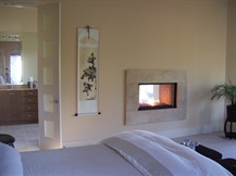 master suite fireplace with glass media