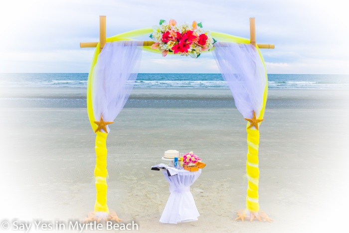 Yellow and white tulle wrapped arbor